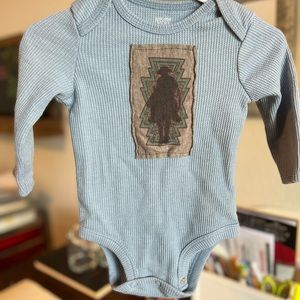 Western design long sleeve onesie.